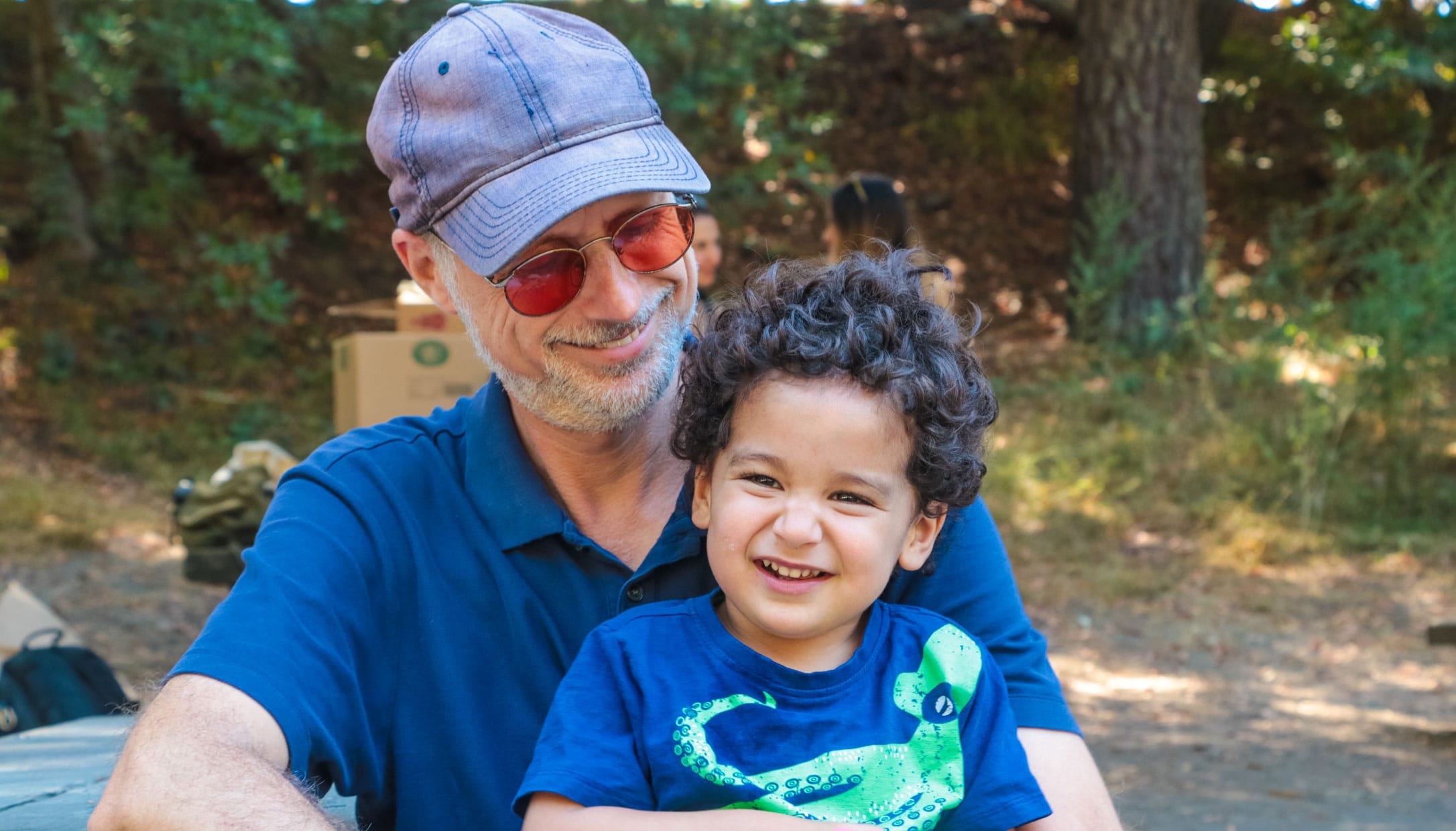 Son sitting on father's lap at Erev Rosh Hashanah celebration