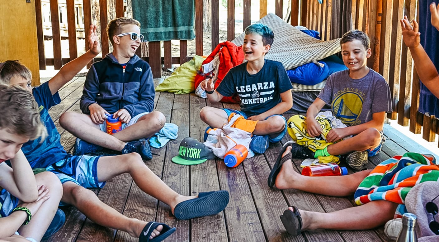 Boys playing games on cabin porch