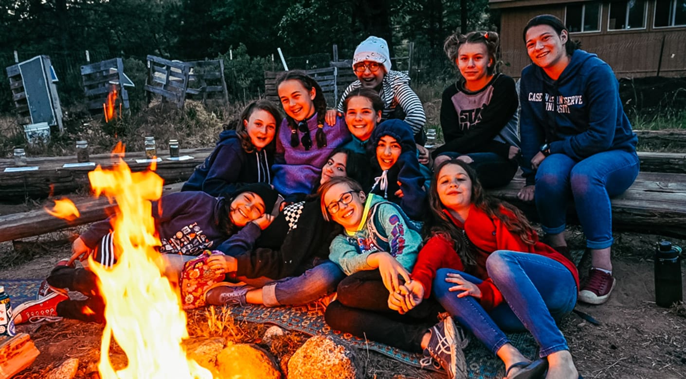 Girls by campfire