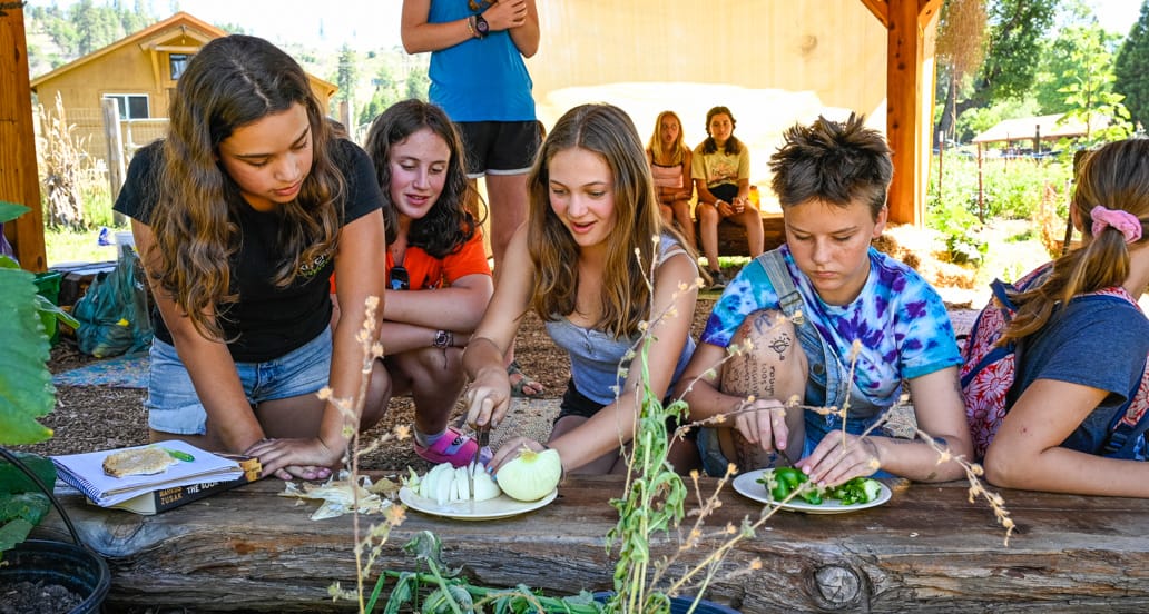 Campers cooking in the outdoor kitchen