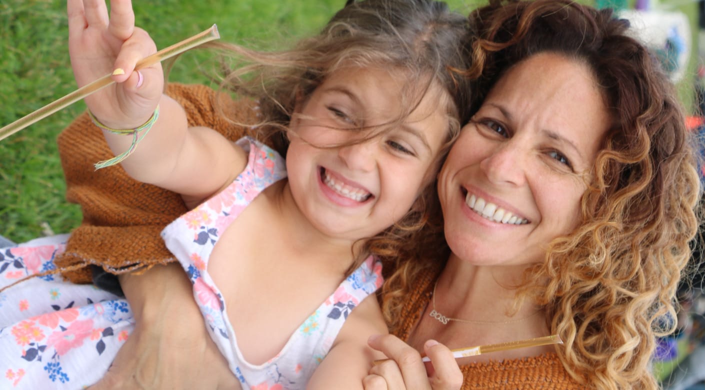 Mother and daughter with honey sticks at Rosh Hashanah