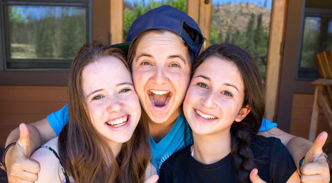 Two teens and staff smiling