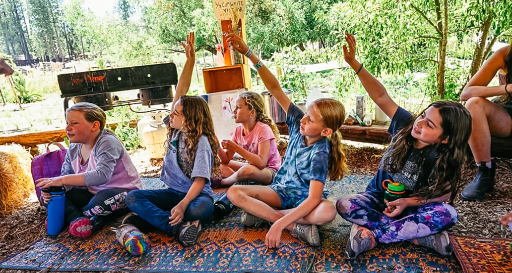 Campers raising their hands in teva