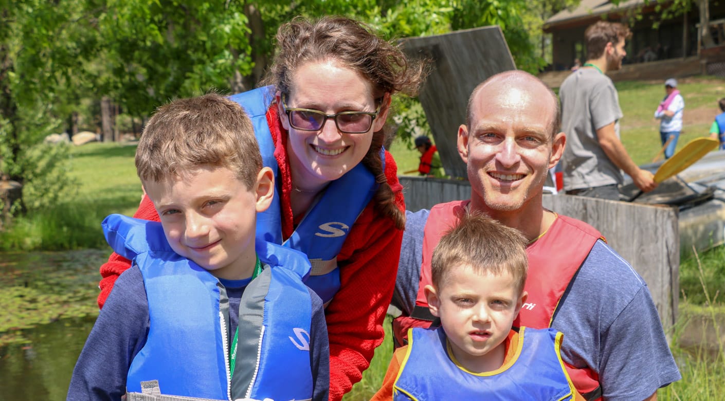 Family wearing life jackets at Family Camp