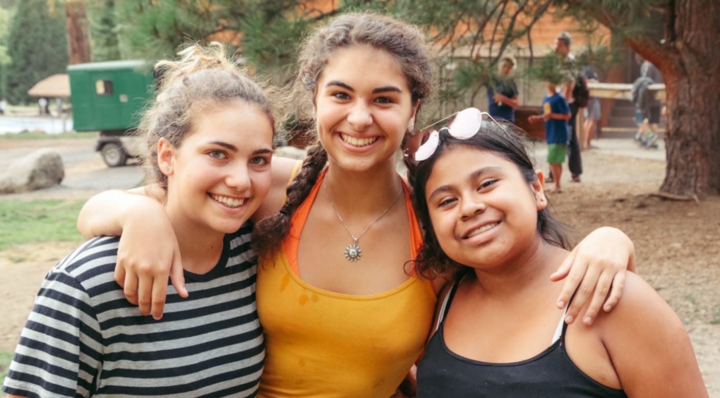 Three teens smiling at Teen Leadership program
