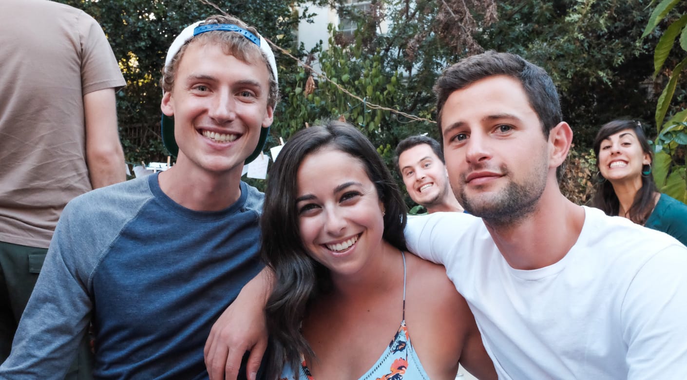 Three alumni smiling at Camp Tawonga