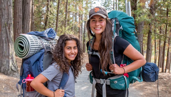 Staff and camper hiking