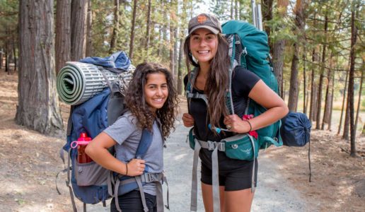 Staff and camper hiking