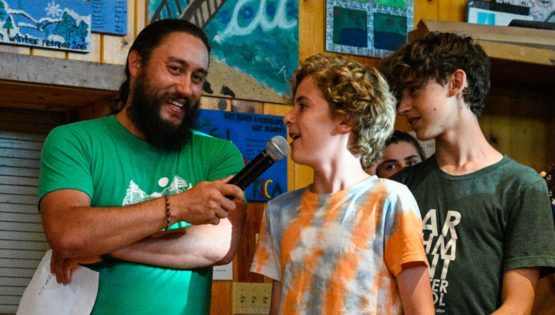 Staff with microphone letting camper speak
