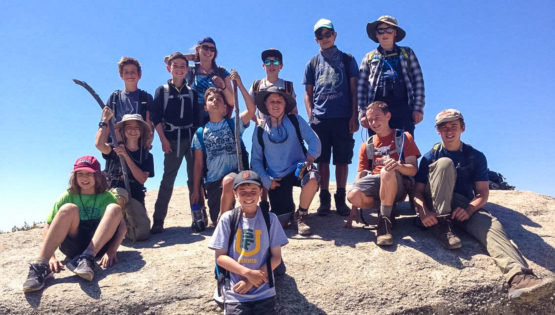 Hikers on rocks on the Sierra Slam quest