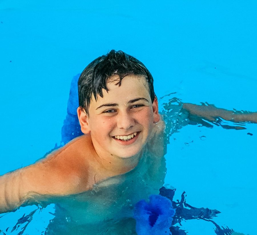 Boy swimming in pool