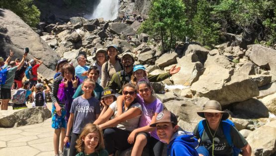 Hikers by waterfall on Taste of Quest