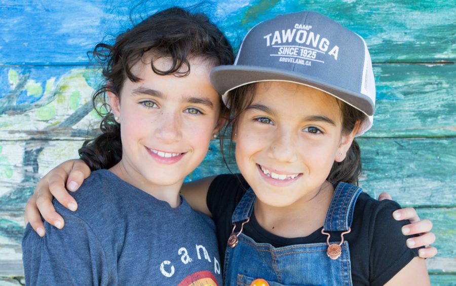 Two girls wearing camp gear