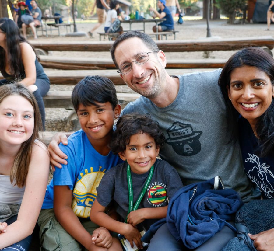 Father and mother with three kids smiling