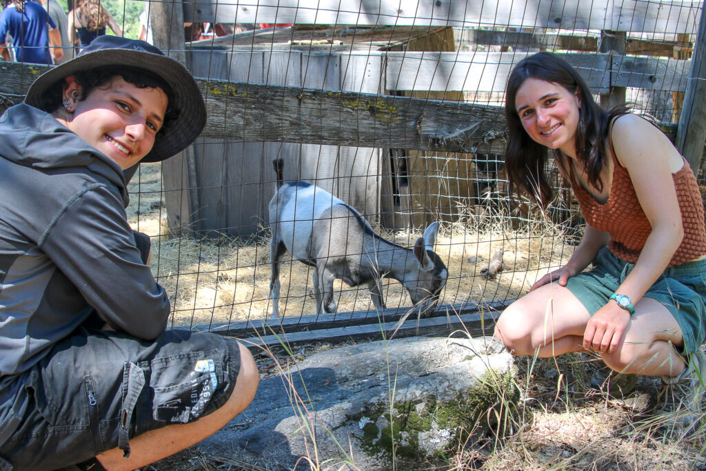 Farm hands Rifka and Jo with one of our goats!